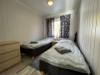 Eines der beiden Schlafzimmer mit Einzelbetten in Apartment 1 & 2.